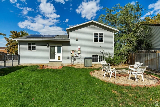 6353 W 3100 S, West Valley City, UT 84128 - back of house with entry steps, solar panels, a fire pit, central AC, and a shingled roof