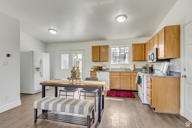 6353 W 3100 S, West Valley City, UT 84128 - kitchen with white appliances, light wood finished floors, and healthy amount of natural light