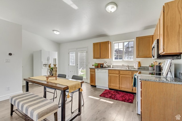 6353 W 3100 S, West Valley City, UT 84128 - kitchen with white appliances, light wood-style floors, healthy amount of natural light, and stone counters