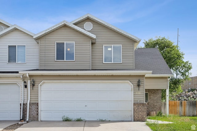 256 Jay Ln, Payson, UT 84651 - traditional home featuring an attached garage, brick siding, and concrete driveway