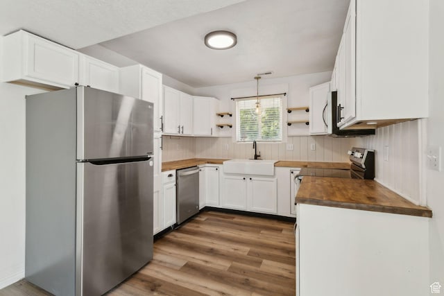 256 Jay Ln, Payson, UT 84651 - kitchen featuring appliances with stainless steel finishes, wood counters, open shelves, a sink, and wood finished floors