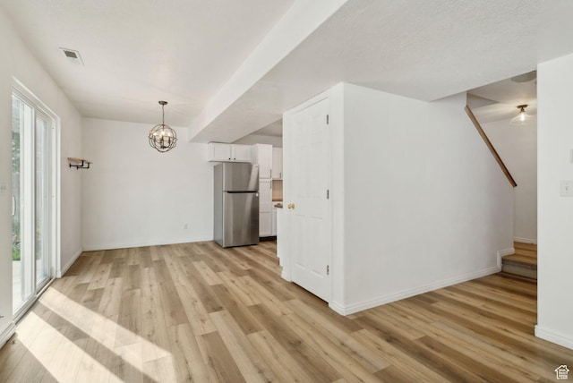 256 Jay Ln, Payson, UT 84651 - unfurnished dining area with light wood-style floors, a chandelier, and baseboards