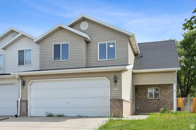 256 Jay Ln, Payson, UT 84651 - view of front facade featuring brick siding, an attached garage, and driveway