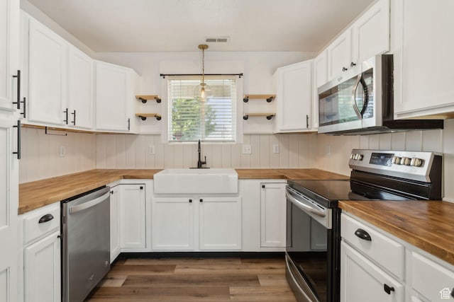 256 Jay Ln, Payson, UT 84651 - kitchen with butcher block countertops, appliances with stainless steel finishes, a sink, and wood walls