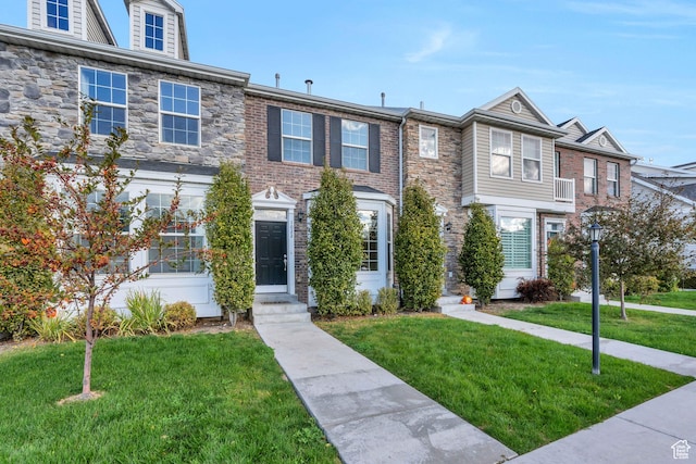 1022 W 500 S, Provo, UT 84601 - townhome / multi-family property with a front yard, entry steps, and stone siding