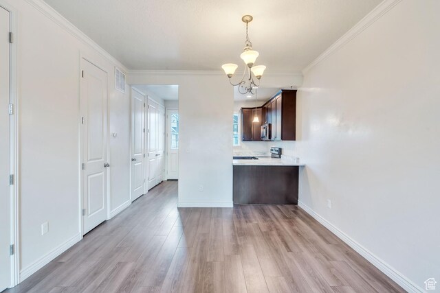 1022 W 500 S, Provo, UT 84601 - kitchen featuring a chandelier, dark brown cabinetry, light countertops, light wood finished floors, and hanging light fixtures