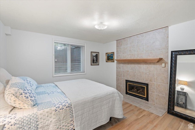 971 E Village Way, Alpine, UT 84004 - bedroom with wood finished floors, a fireplace, and a textured ceiling