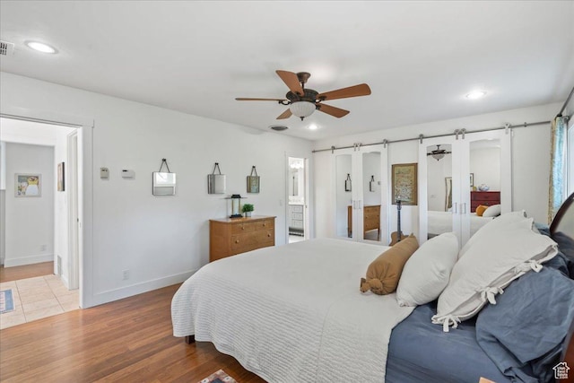 971 E Village Way, Alpine, UT 84004 - bedroom with a barn door, ensuite bathroom, wood finished floors, baseboards, and recessed lighting