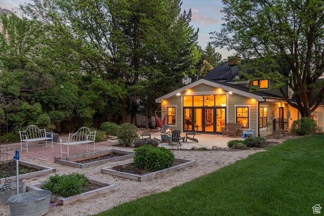971 E Village Way, Alpine, UT 84004 - back of property at dusk with a garden, a patio area, a fire pit, and a yard