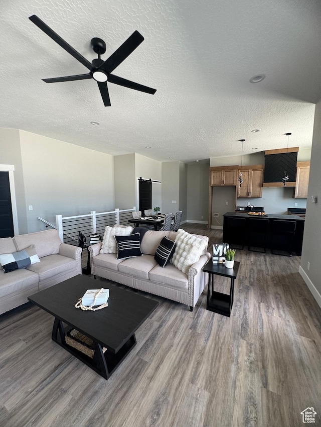 565 E Otto Ln Unit 421, Grantsville, UT 84029 - living area featuring wood finished floors, a textured ceiling, ceiling fan, and baseboards