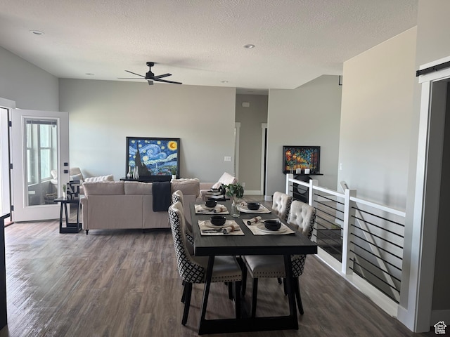 565 E Otto Ln Unit 421, Grantsville, UT 84029 - dining room featuring dark wood-style floors, ceiling fan, a barn door, a textured ceiling, and baseboards