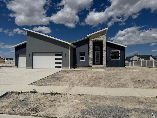 565 E Otto Ln Unit 421, Grantsville, UT 84029 - view of front of property featuring a garage, driveway, and stone siding