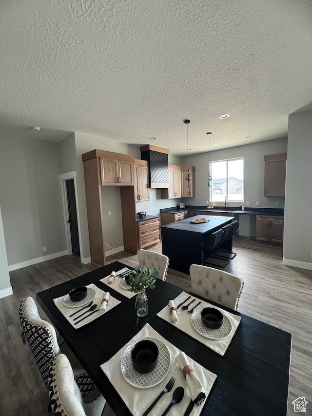 565 E Otto Ln Unit 421, Grantsville, UT 84029 - dining area with a textured ceiling, light wood-style floors, and baseboards