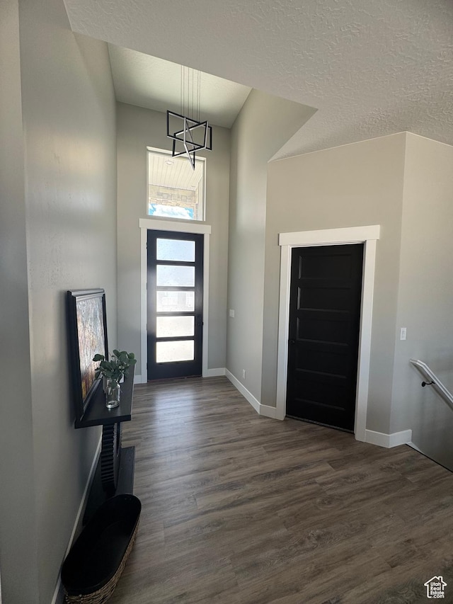 565 E Otto Ln Unit 421, Grantsville, UT 84029 - entryway featuring dark wood-style flooring, baseboards, a chandelier, and a textured ceiling