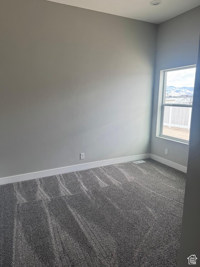 565 E Otto Ln Unit 421, Grantsville, UT 84029 - spare room featuring dark carpet and baseboards
