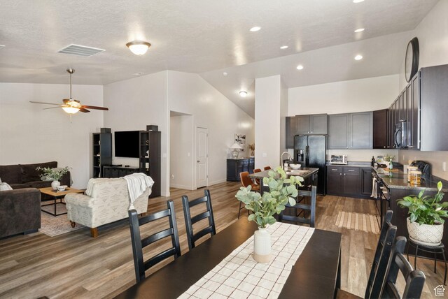 1135 Surrey Dr, North Salt Lake, UT 84054 - dining space featuring light wood finished floors, lofted ceiling, ceiling fan, recessed lighting, and baseboards