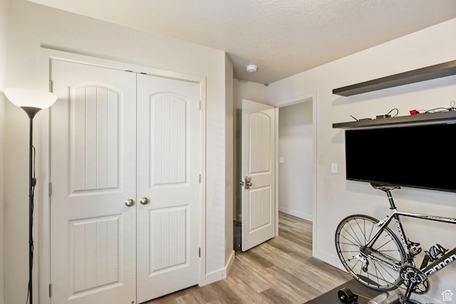 1135 Surrey Dr, North Salt Lake, UT 84054 - bedroom featuring light wood finished floors, baseboards, a closet, and a textured ceiling