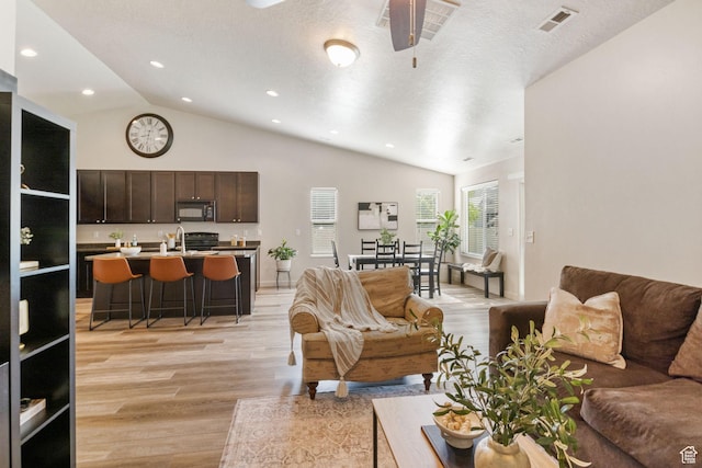 1135 Surrey Dr, North Salt Lake, UT 84054 - living area featuring light wood-type flooring, lofted ceiling, ceiling fan, recessed lighting, and baseboards