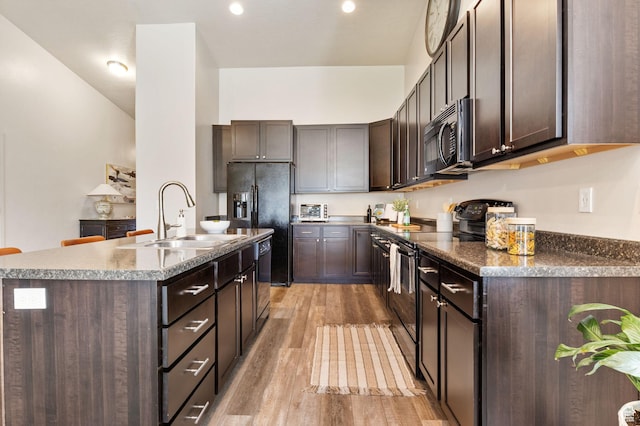 1135 Surrey Dr, North Salt Lake, UT 84054 - kitchen featuring black appliances, a sink, dark brown cabinets, and light wood-style flooring
