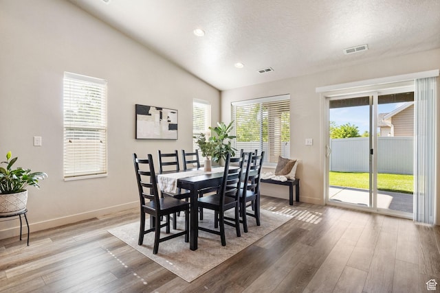 1135 Surrey Dr, North Salt Lake, UT 84054 - dining area featuring light wood finished floors, baseboards, vaulted ceiling, a textured ceiling, and recessed lighting