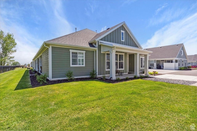 94 N 3830 W, West Point, UT 84015 - view of front of property with board and batten siding, a front yard, driveway, and a shingled roof