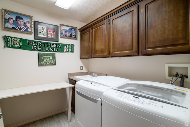 576 S Fiesta Dr, Ivins, UT 84738 - laundry area featuring washer and clothes dryer, cabinet space, and a textured ceiling