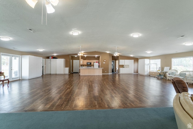 576 S Fiesta Dr, Ivins, UT 84738 - living area featuring a ceiling fan, lofted ceiling, dark wood-style flooring, a textured ceiling, and baseboards