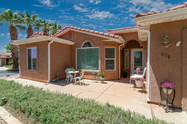 576 S Fiesta Dr, Ivins, UT 84738 - rear view of house with a patio area, stucco siding, and a tile roof