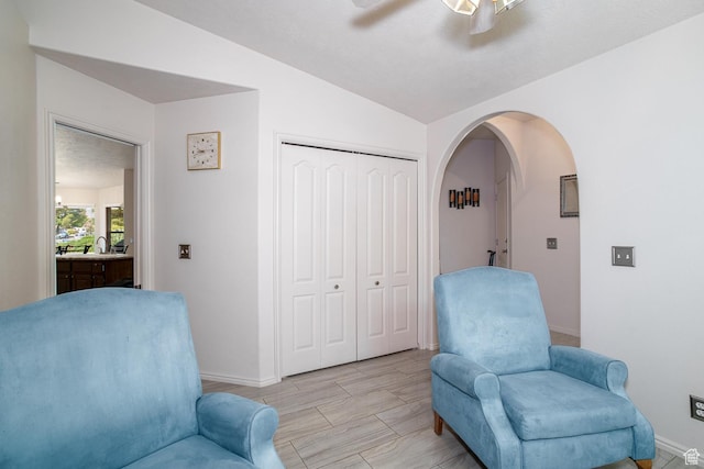 576 S Fiesta Dr, Ivins, UT 84738 - sitting room featuring arched walkways, baseboards, vaulted ceiling, and ceiling fan