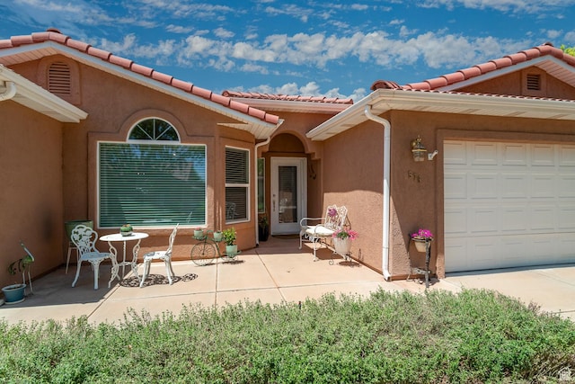 576 S Fiesta Dr, Ivins, UT 84738 - property entrance with stucco siding, a tile roof, and a garage