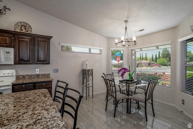 576 S Fiesta Dr, Ivins, UT 84738 - dining space with a chandelier and baseboards