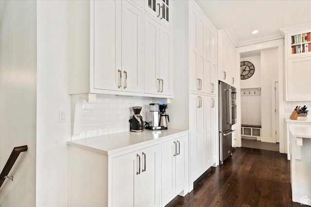 848 S Greenwood Ter E, Salt Lake City, UT 84105 - kitchen with high end fridge, tasteful backsplash, light countertops, white cabinets, and dark wood-style floors
