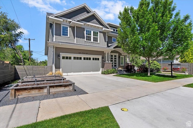 848 S Greenwood Ter E, Salt Lake City, UT 84105 - craftsman house with board and batten siding, a garden, driveway, and an attached garage