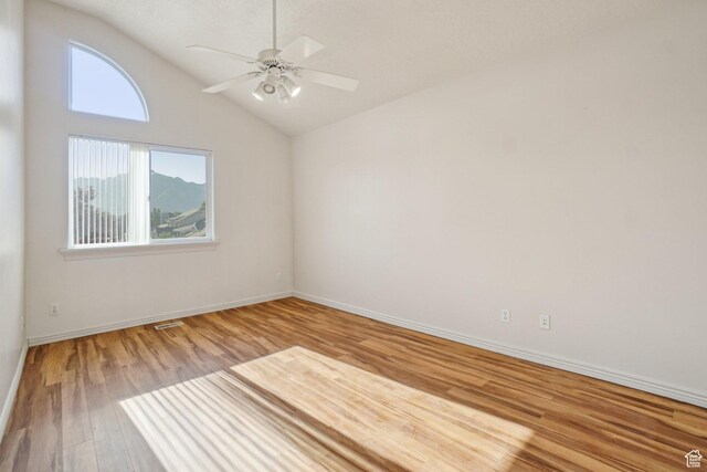 4538 Cottage Grove Ln, Murray, UT 84107 - unfurnished room with wood finished floors, lofted ceiling, a ceiling fan, and baseboards