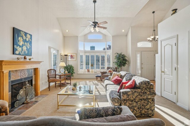 4538 Cottage Grove Ln, Murray, UT 84107 - living area with high vaulted ceiling, a tile fireplace, ceiling fan, baseboards, and a chandelier
