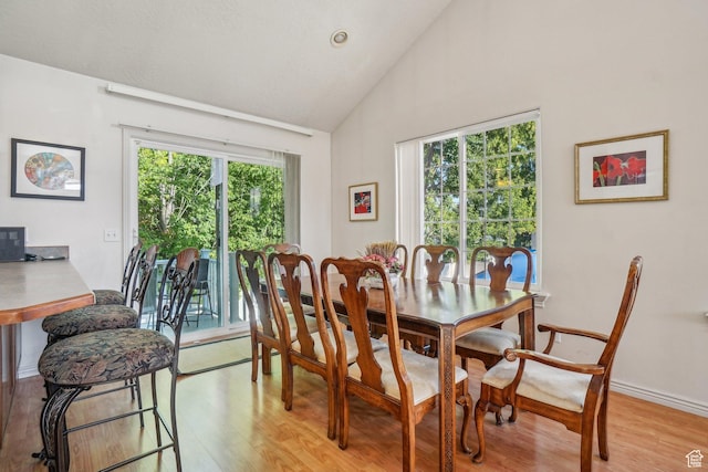 4538 Cottage Grove Ln, Murray, UT 84107 - dining room with light wood-type flooring, high vaulted ceiling, and baseboards