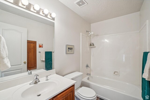4538 Cottage Grove Ln, Murray, UT 84107 - bathroom with  shower combination, vanity, toilet, and a textured ceiling