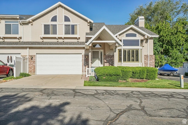 4538 Cottage Grove Ln, Murray, UT 84107 - view of front facade with driveway, stucco siding, brick siding, a garage, and a chimney