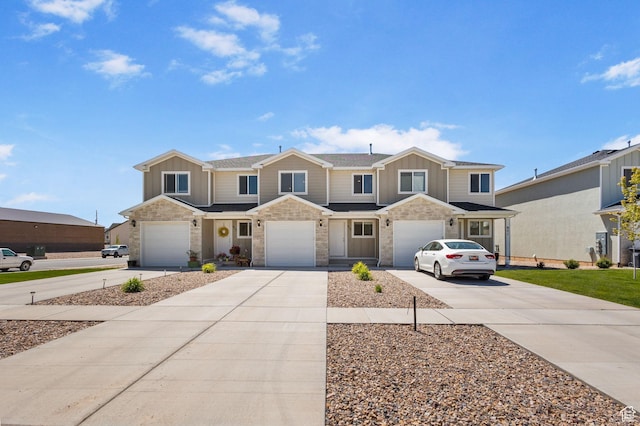 971 N 100 W, Nephi, UT 84648 - townhome / multi-family property with concrete driveway, board and batten siding, a garage, and stone siding