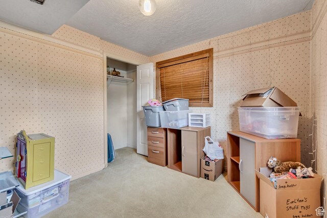 1789 N Stayner Dr W, Farmington, UT 84025 - carpeted bedroom featuring wallpapered walls, a textured ceiling, and a closet