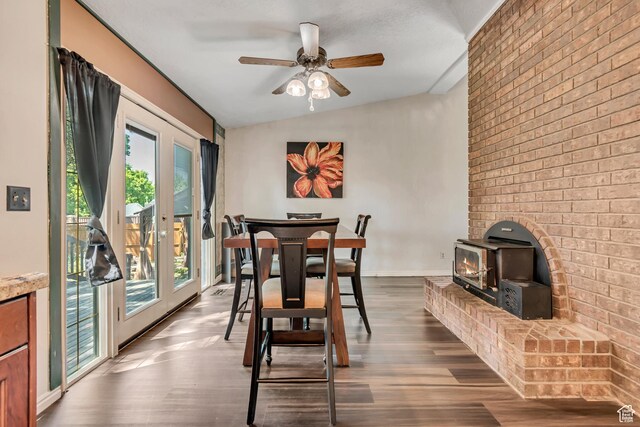1789 N Stayner Dr W, Farmington, UT 84025 - dining space featuring a wood stove, plenty of natural light, dark wood-style flooring, brick wall, and lofted ceiling