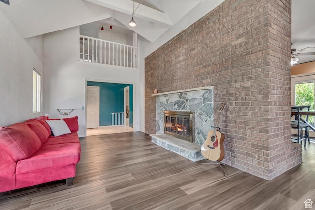 1789 N Stayner Dr W, Farmington, UT 84025 - living area featuring wood finished floors, a fireplace, high vaulted ceiling, radiator heating unit, and ceiling fan