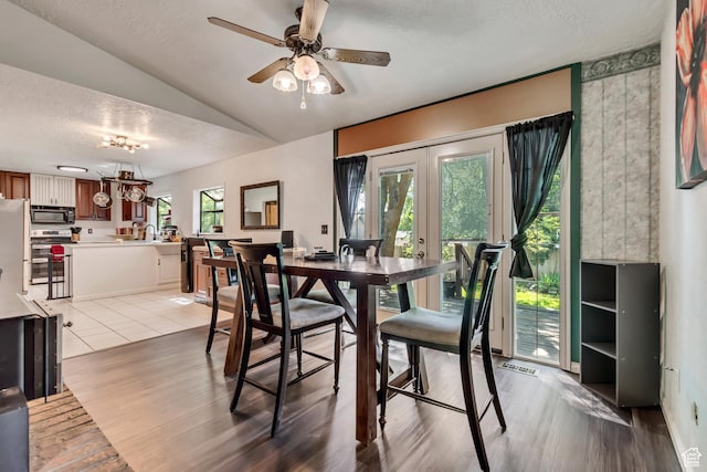1789 N Stayner Dr W, Farmington, UT 84025 - dining room with a textured ceiling, lofted ceiling, light wood finished floors, a ceiling fan, and french doors
