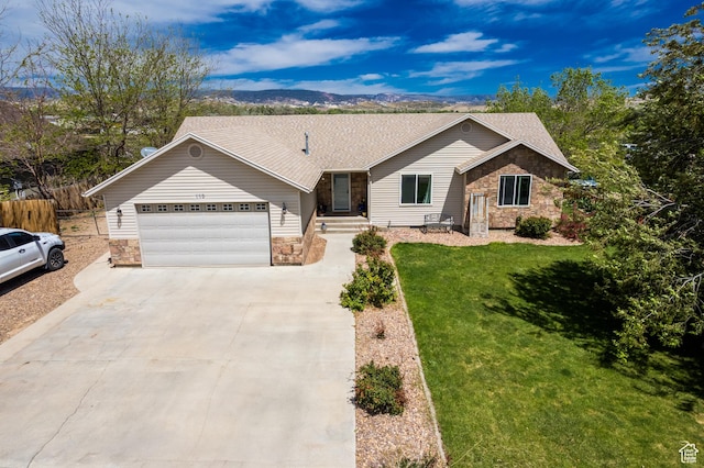 113 E 1500 N, Vernal, UT 84078 - ranch-style home featuring stone siding, a garage, driveway, a shingled roof, and a mountain view