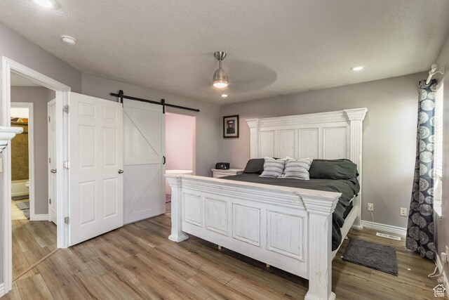 113 E 1500 N, Vernal, UT 84078 - bedroom with a barn door, light wood-type flooring, baseboards, recessed lighting, and ceiling fan