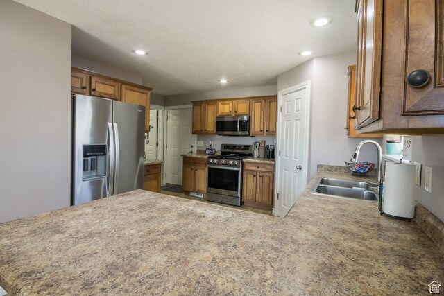 113 E 1500 N, Vernal, UT 84078 - kitchen with appliances with stainless steel finishes, a sink, brown cabinets, recessed lighting, and a peninsula