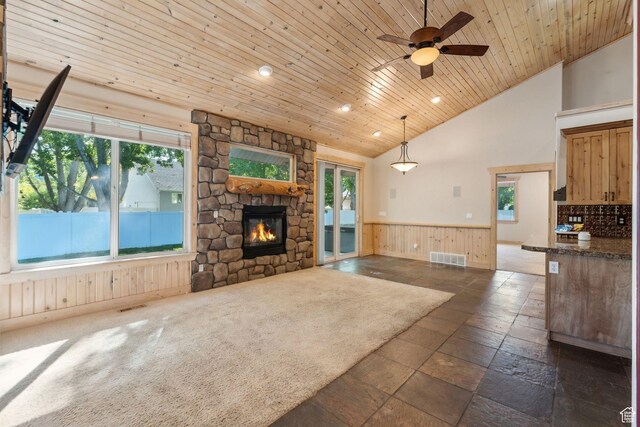 280 N Mill Rd, Heber City, UT 84032 - unfurnished living room featuring a wainscoted wall, a stone fireplace, ceiling fan, stone tile floors, and recessed lighting