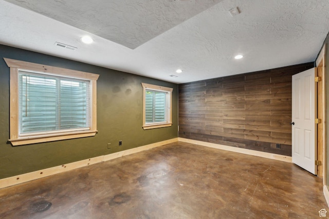 280 N Mill Rd, Heber City, UT 84032 - unfurnished room featuring wooden walls, concrete flooring, recessed lighting, a textured ceiling, and baseboards
