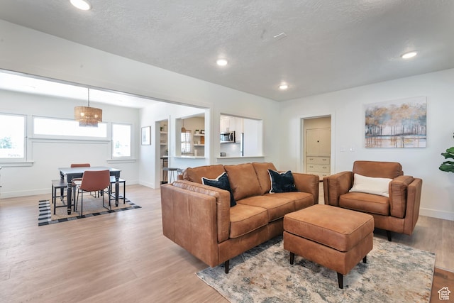 292 S 100 W, Provo, UT 84601 - living area with light wood-type flooring, baseboards, recessed lighting, and a textured ceiling
