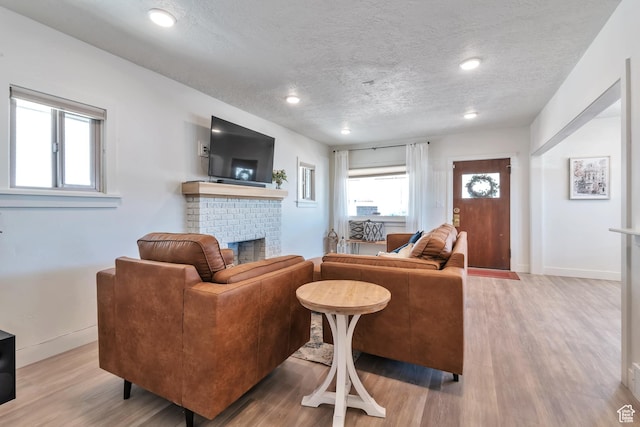 292 S 100 W, Provo, UT 84601 - living area featuring a fireplace, wood finished floors, a textured ceiling, baseboards, and recessed lighting
